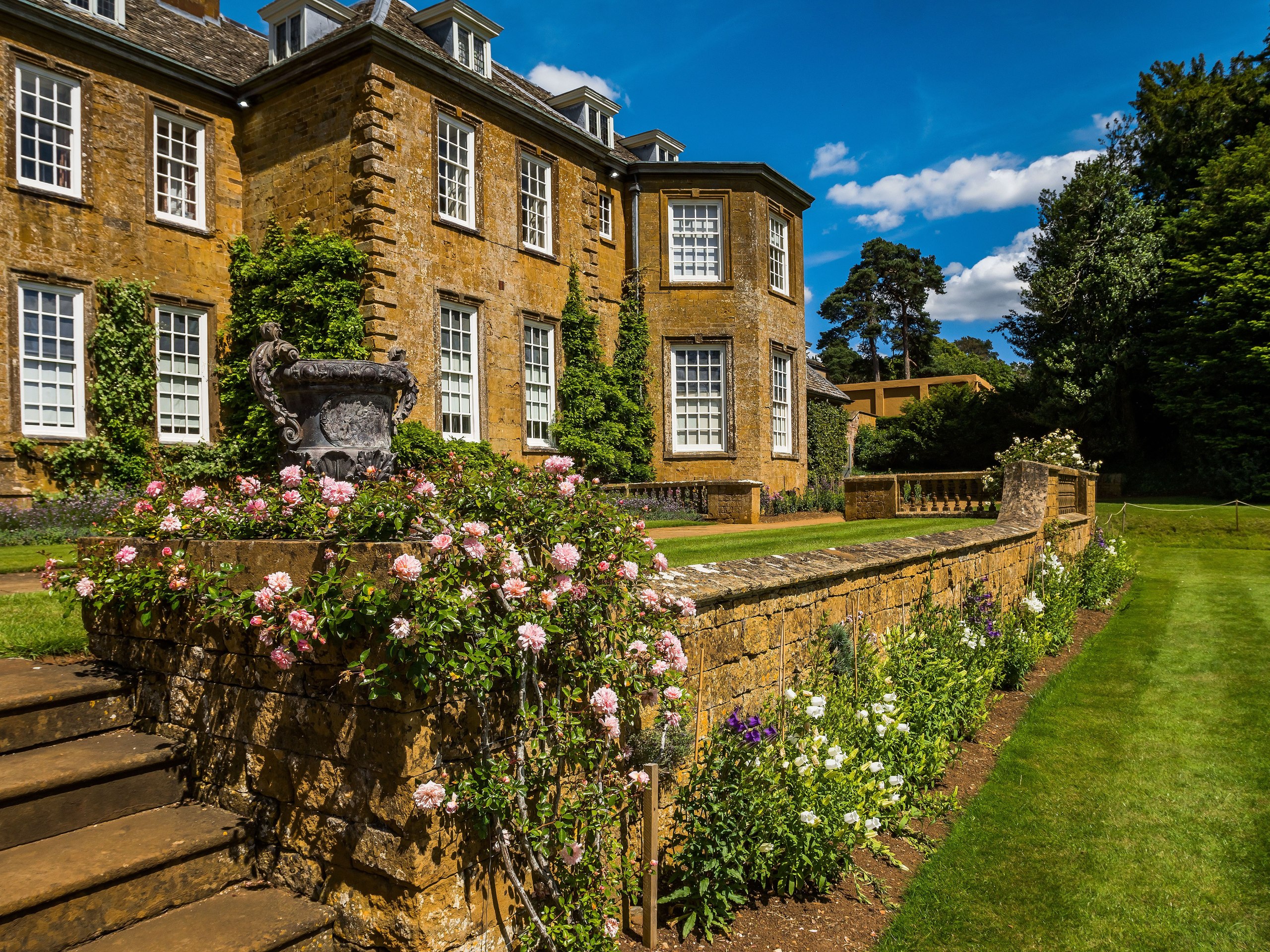 Stone country house and rose garden in the home counties