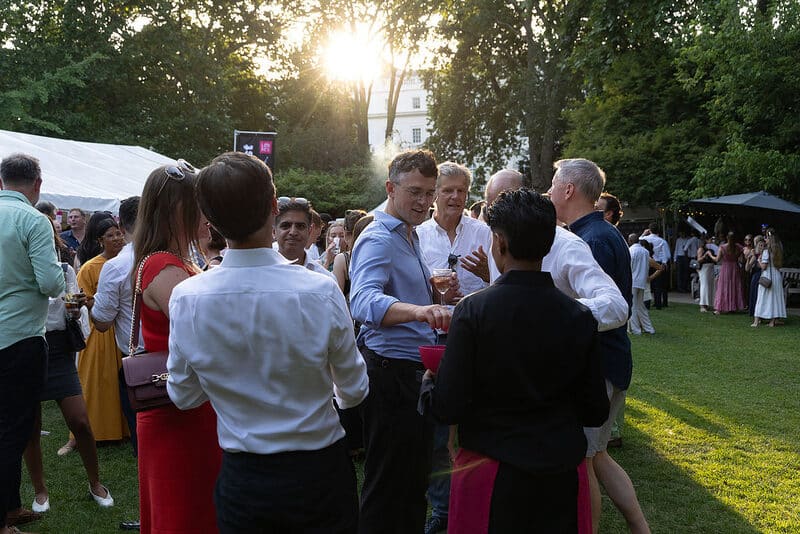 Guests in the garden at golden hour at the LonRes Summer Party