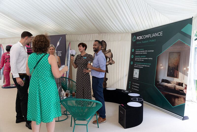 Guests at a sponsor stand in the marquee at the LonRes Summer Party