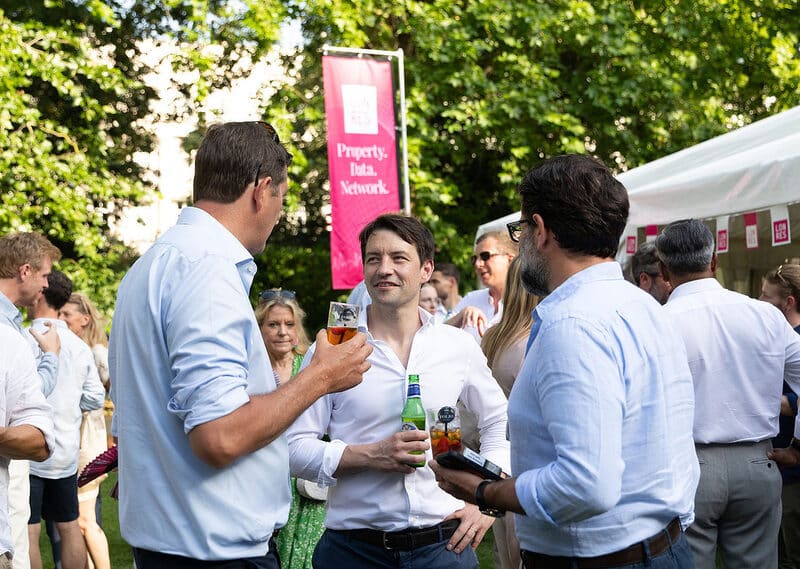 Guests talking in the garden at the LonRes Summer Party